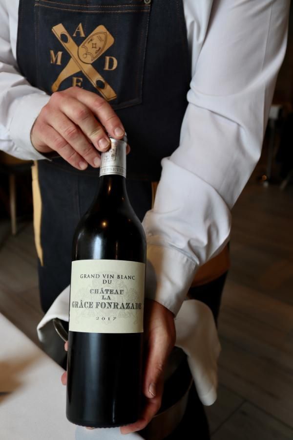 Sumiller de MADE Restaurante presentando un vino